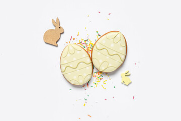 Wall Mural - Sprinkles and tasty Easter cookies in shape of egg isolated on white background