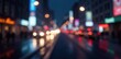 © Kachaphot - Soft glow of city lights against a dark abstract background with subtle white and gray bokeh effect, conveying a sense of urban nightlife, urban scene, motion blur