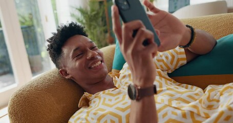 Poster - Happy man, phone and smile to relax on social media for rest or comfort on weekend in home on sofa. Chilling, technology and male person with mobile on couch for calm peace and online dating on app