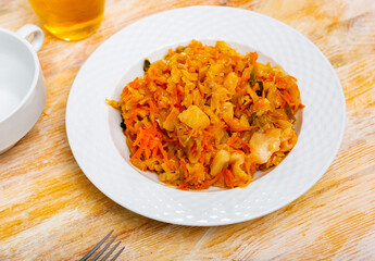 Wall Mural - Popular dish of Russian cuisine, made of delicious stewed cabbage with vegetables