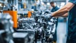 © Mcgui - Automotive factory. Workers assembling car engines. Highlighting precision engineering and teamwork in automotive manufacturing. Ideal for automotive industry reports.