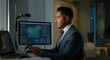 © Postmodern Studio - A man in a suit is sitting at a desk with two computer monitors and a cell phone