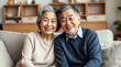 © adynue - Portrait happy Asian mature senior couple sitting on the sofa look at the camera and smiling. Family mature couple portrait