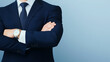 © pattozher - Confident and Composed: A close-up shot of a businessman in a dark blue suit with a white shirt and a dark blue tie, standing with his arms crossed.
