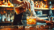 © NORN - Crafting the Cocktail: Expert bartender's hand pours amber liquid over ice into a rocks glass, showcasing the art of mixology in a dimly lit bar setting.