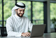 © Usama - Smiling Arab Businessman Using Laptop, Modern Office, Professional
