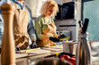© Zoran Zeremski - Middle-aged couple enjoying a cooking class with a chef preparing leek for a meal in the kitchen.