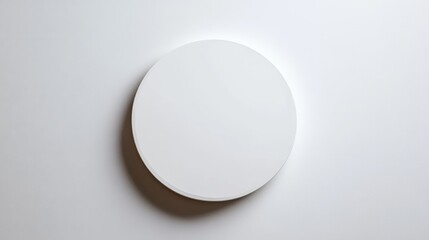 Poster - Minimalist round white plate on a plain surface with soft lighting and clean aesthetic