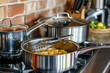 © gd-house - Cooking Spaghetti in a Stainless Steel Pan – Kitchen Scene with Modern Cookware
