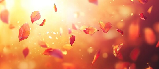 Fototapete - Autumn leaves gently falling in warm golden sunlight with a dreamy blurred background featuring hues of orange and red.