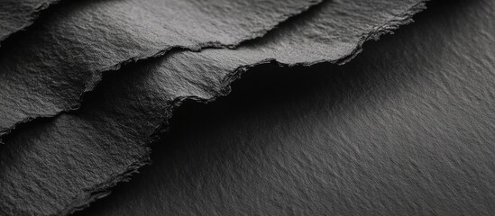 Poster - textured dark gray and black layered surface with smooth edges and subtle sheen creating a layered d