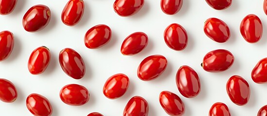 Aufkleber - Bright red cherry tomatoes scattered on a white background, showcasing their vibrant color and glossy texture for a fresh and appetizing look.