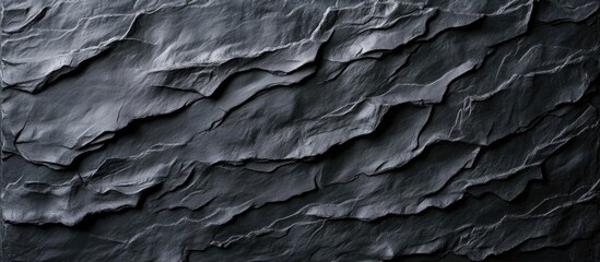 Poster - Textured dark slate surface with layered, rippled patterns in varying shades of black and gray positioned diagonally across the image.