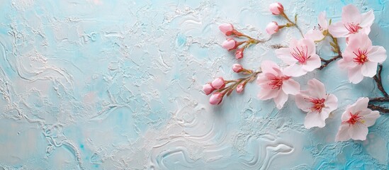 Aufkleber - Soft pink cherry blossoms on a textured blue background, with delicate petals positioned on the top left, creating a serene and tranquil atmosphere.