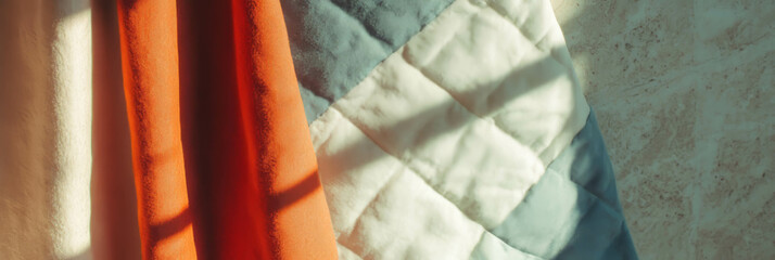 Aufkleber - Quilted cotton fabric draped artistically against a textured background in soft sunlight
