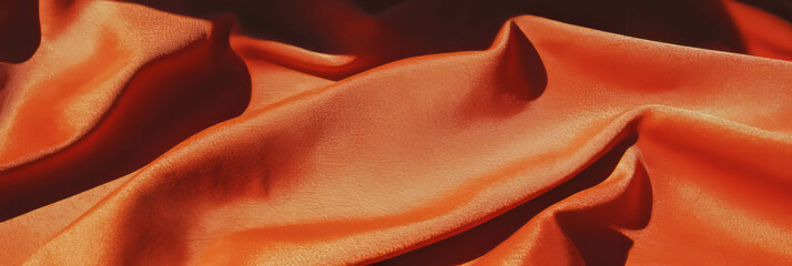 Poster - Rust brown suede fabric featuring intricate folds and deep shadows under side lighting