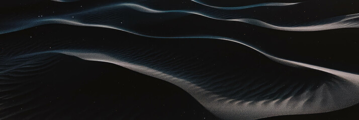 Poster - Rippling textures of a black sand dune illuminated by soft lighting at dusk