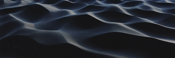 Poster - Texture of black sand interspersed with fragmented volcanic rock casts deep shadows
