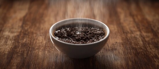 Aufkleber - Freshly brewed coffee in a white bowl with steam rising, placed on a rustic wooden table, showcasing dark coffee grounds being dripped.