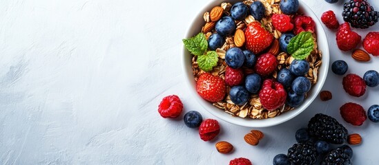Poster - Colorful bowl of mixed berries including strawberries blueberries raspberries and blackberries on light stone surface with granola and nuts arranged artistically