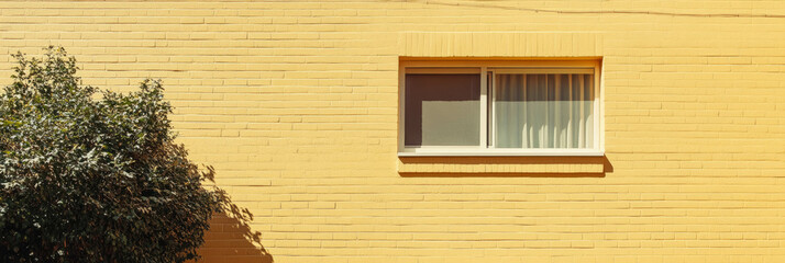 Poster - Light golden sand yellow wall with grainy texture and window view in bright sunlight