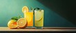 © Nijat - Refreshing lemonade and orange juice served in clear glasses with mint leaves on a wooden table against a green background highlighting vibrant colors