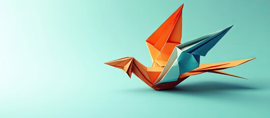 Leinwandbilder - Colorful origami bird in orange and blue tones, positioned on a soft teal background, showcasing intricate folds and artistic design.