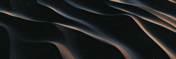 Poster - Smooth black sand dunes exhibit graceful windblown patterns in an undulating landscape