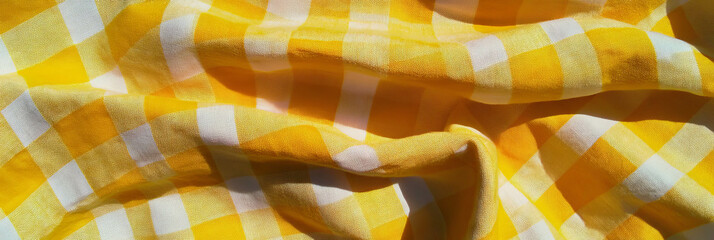 Poster - Bright yellow gingham tablecloth with crisp texture and small squares in natural light