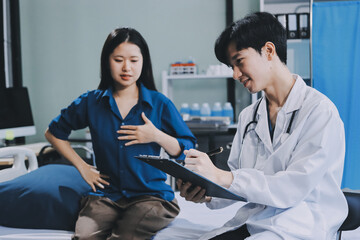 Wall Mural - doctor consulting senior old patient filling form at consultation. Professional physician wearing white coat talking to mature woman signing medical paper at appointment visit in clinic.