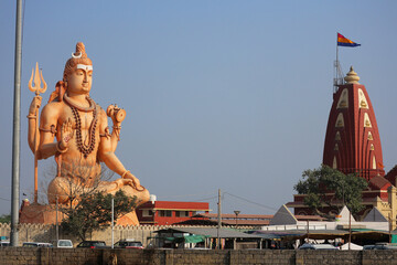 Sticker - A giant statue of Shiva meditating near the Nilganagiri Mahadev Temple in Gujarat, India.