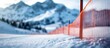 © pngking - Slalom gate on alpine ski course with blurred slope and snowy mountains in background creating empty space for text or branding.