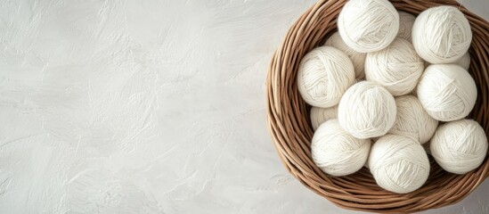 Poster - Wool Yarn Basket with Soft White Thread Balls on a Light Background Perfect for Crafting and Design Projects