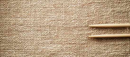 Poster - Wool yarn and wooden knitting needles on textured burlap with ample space for personalized text or branding applications