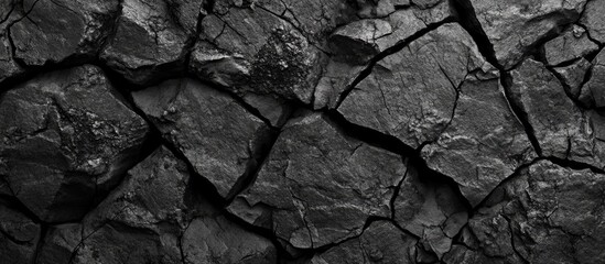 Aufkleber - Black cracked rock texture with intricate patterns ideal for backgrounds, design projects, or artistic concepts in various applications.