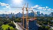 © Old Man Stocker - Aerial View of Urban Construction Site with Cranes Overlooking City Skyline and Lush Greenery under Bright Blue Sky