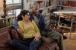 © ReeldealHD images - Couple Sharing Smartphone on Couch in Cozy Living Room
