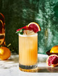 © Michael Marquand - cocktail in a tall glass with blood orange and mint garnish