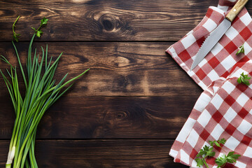 Aufkleber - Rustic wooden background with fresh green onions and a napkin, top-down view with space for text