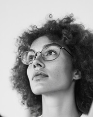 Poster - Contemporary Monochrome Portrait Curly-Haired Woman with Glasses - Artistic Expression for Digital Marketing and Creative Branding in Modern Lifestyle Imagery