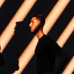 Poster - Contemporary Portrait Dynamic Light and Shadow Play on Male Subject in Black Tee - Visual Storytelling and Creative Content for Modern Marketing