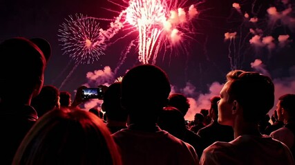 Poster - Spectators recording videos of colorful fireworks exploding in the night sky during a festive celebration, captured in a slow motion montage