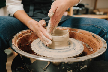 Poster - Potter creates a ceramic bowl in the pottery studio. Process of making a unique ceramic shape.