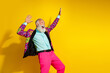 © deagreez - Portrait of isolated on overjoyed aged man colorful designer clothes dance empty space yellow background