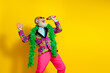 © deagreez - Portrait of crazy extravagant man classy clothes sing microphone empty space isolated on yellow color background