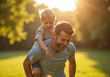© BeaRod - father piggybacks little son outside playing ball warm sun saturday