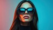 © Oleksandr - Striking portrait of a confident woman wearing oversized sunglasses in a vibrant blue and pink setting