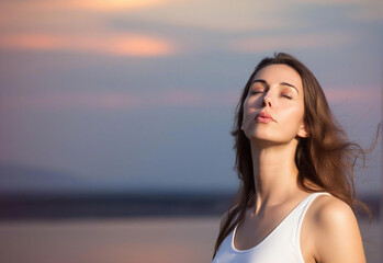 Wall Mural - Extreme close-up portrait of a woman with long hair blowing in the wind, eyes closed, with the soft colors of a sunset behind her.