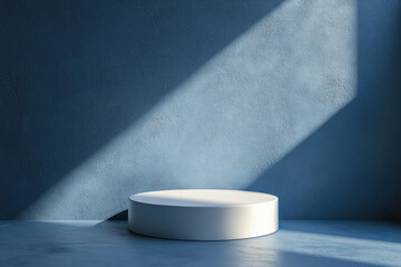 Poster - Minimalist white cylindrical platform against a textured blue wall, bathed in sunlight.