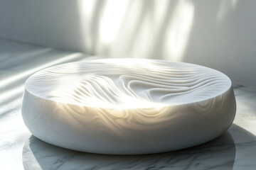 Poster - White bowl with carved wave patterns, illuminated by sunlight, rests on marble.